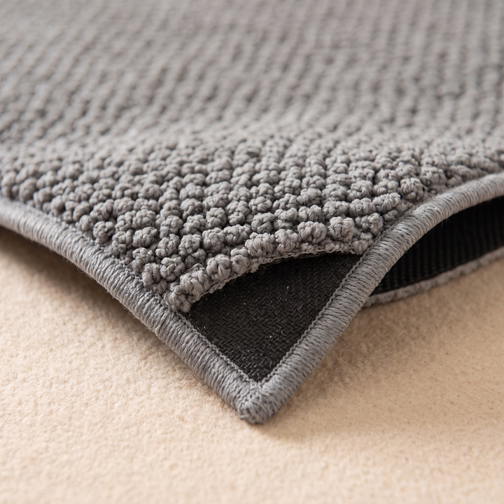Indoor Door Mat – Washable, Non-Slip in Gray – close-up of a lifted corner showing the black backing and stitched edge