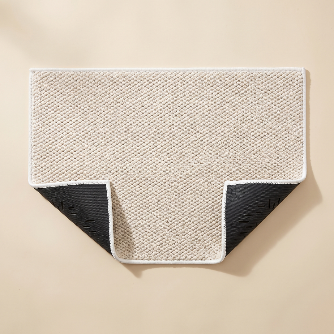 Indoor Door Mat – Washable, Non-Slip in Cream – top-down view with two corners folded up showing the non-slip backing