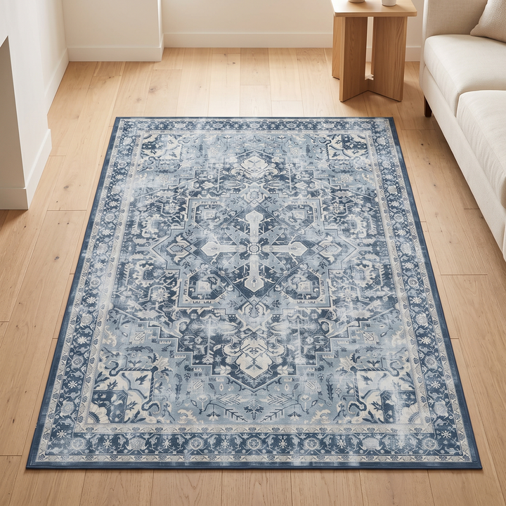 Washable Vintage Persian-Style Rug in Blue Medallion – laid flat on a light wood floor beside a sofa