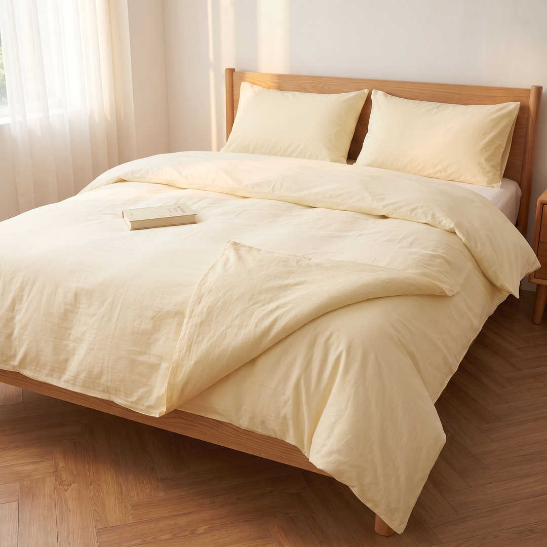 Washed Cotton Duvet Cover Set in Light Yellow – seen from the foot of the bed with a diagonal turned-over fold