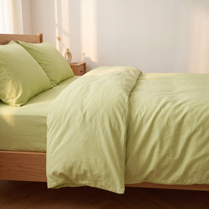 Washed Cotton Duvet Cover Set in Lime Green – side view of duvet hanging loosely over the bed frame edge