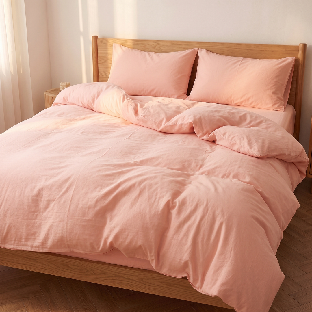 Washed Cotton Duvet Cover Set in Peach – corner angle with sunlight raking across the duvet folds