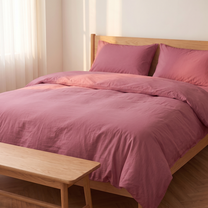 Washed Cotton Duvet Cover Set in Rose – bed seen past a wooden bench at its foot