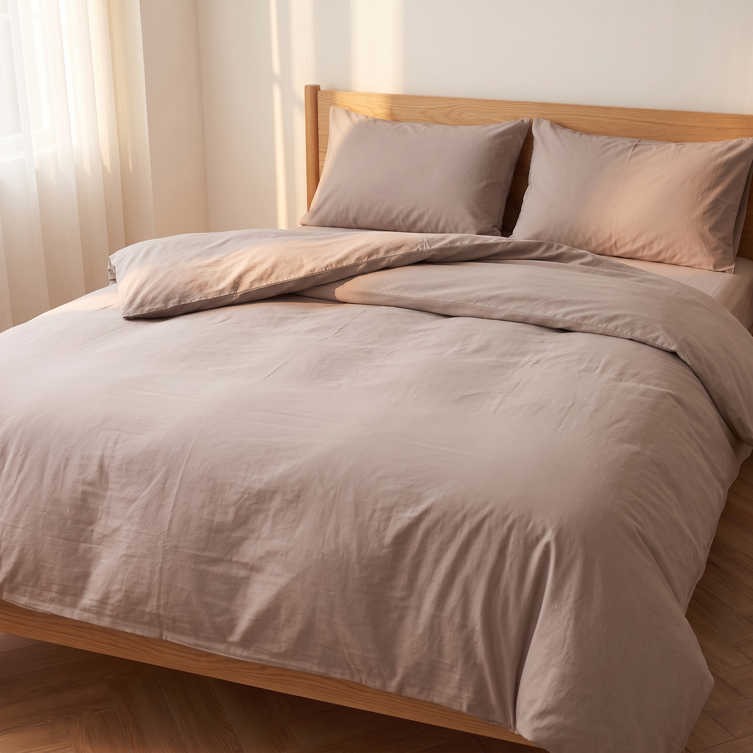 Washed Cotton Duvet Cover Set in Taupe – three-quarter angle with duvet folded back beside two pillows