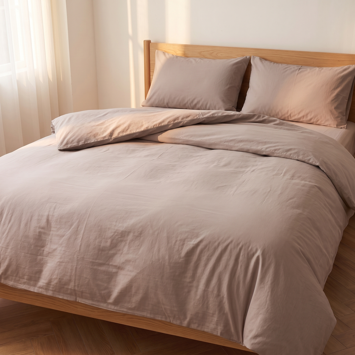 Washed Cotton Duvet Cover Set in Taupe – three-quarter angle with duvet folded back beside two pillows
