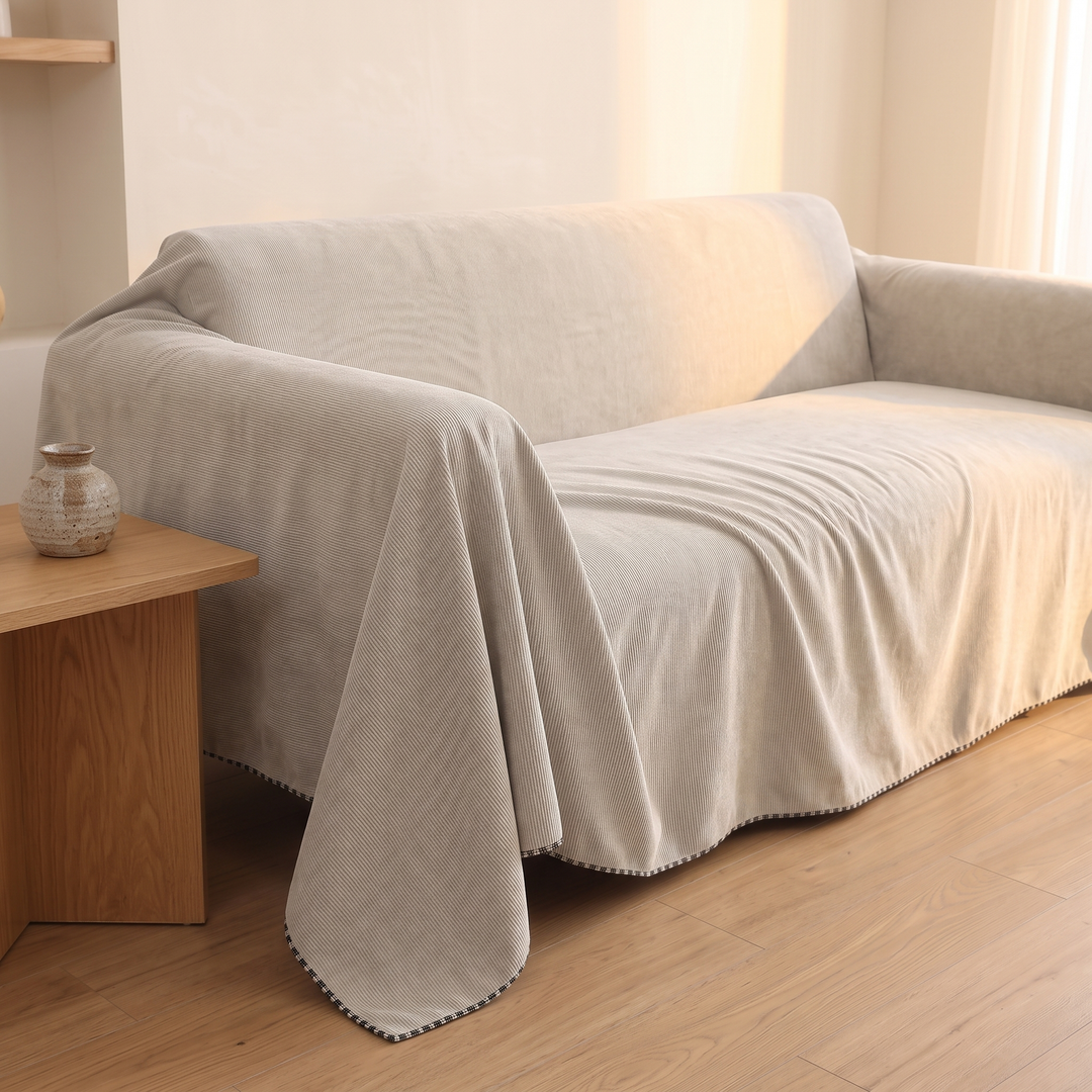 Water-Resistant Couch Cover – Throw Style in Oatmeal – sunlit living room corner with wooden side table and vase