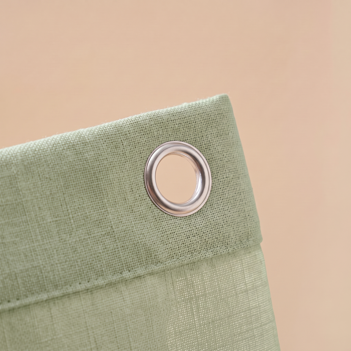 Close-up of the green linen-look weave and metal grommet