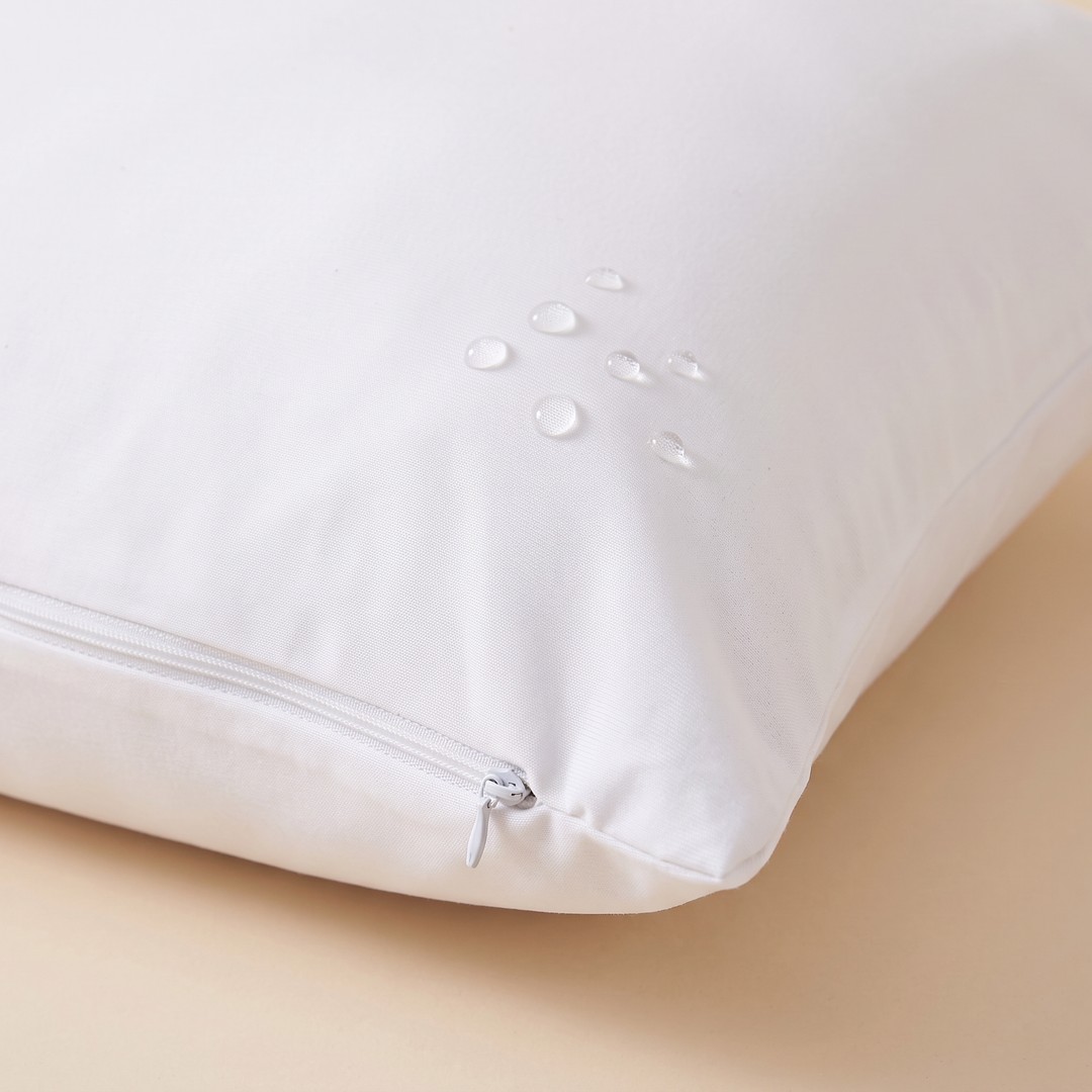 Waterproof Pillow Protector in White – close-up of water droplets beading on the fabric near the zipper pull