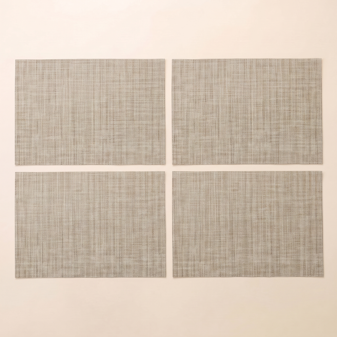 Woven Placemats – Wipe Clean in Beige – Crosshatch – four placemats arranged in a two by two grid on plain cream background