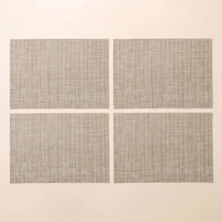 Woven Placemats – Wipe Clean in Beige – Crosshatch – four placemats arranged in a two by two grid on plain cream background