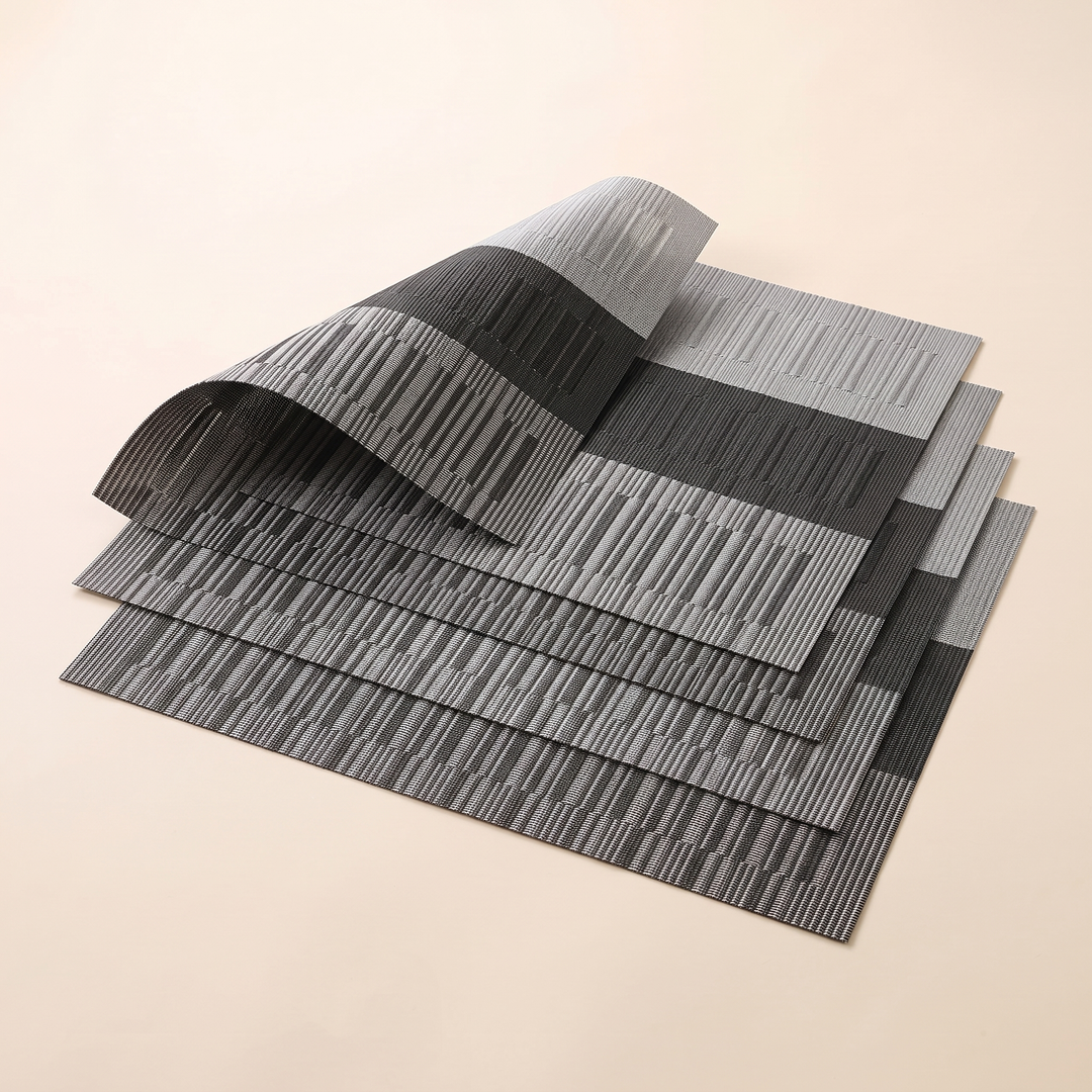 Woven Placemats – Wipe Clean in Black &amp; Gray – Block Stripe – stepped stack of four with top corner sweeping upward
