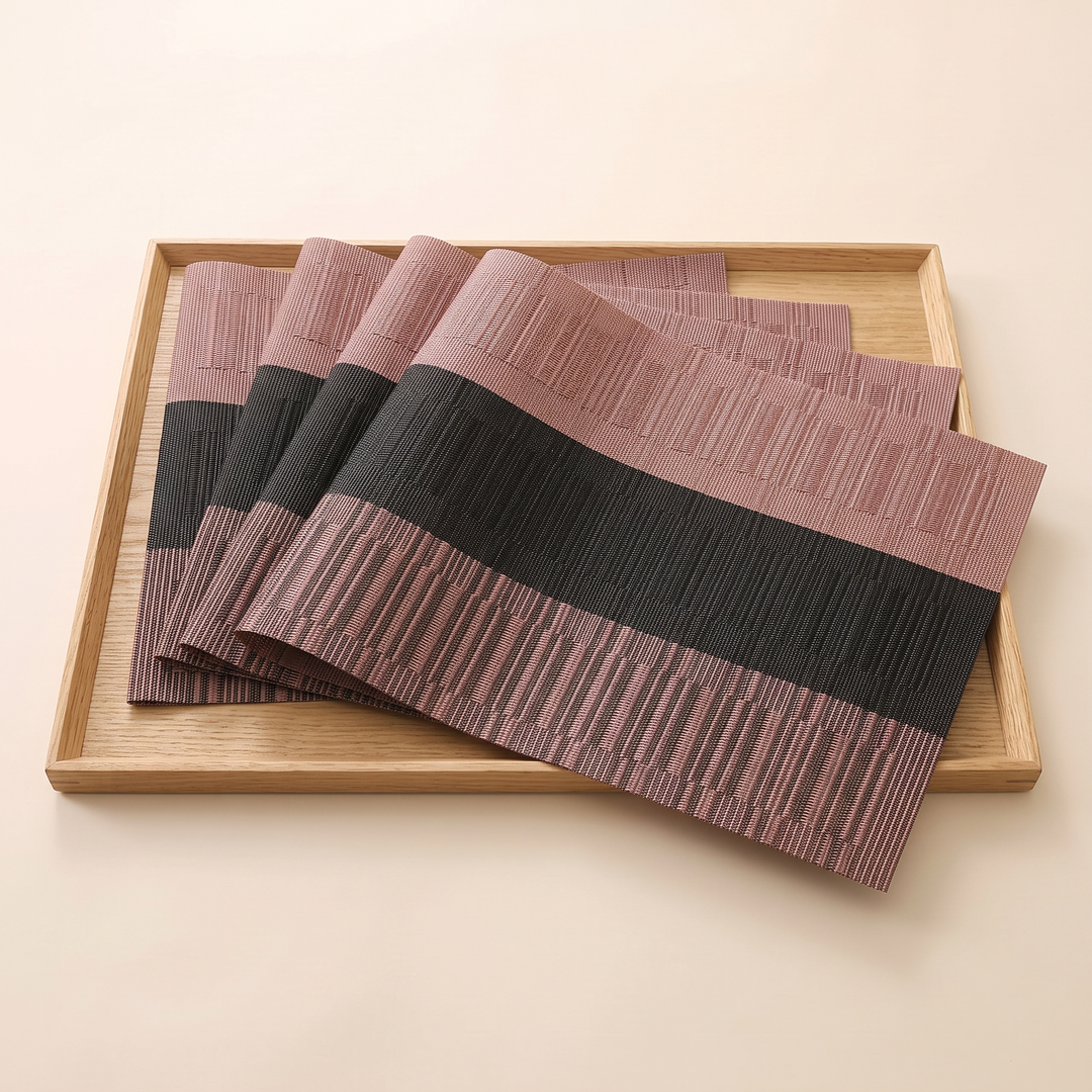 Woven Placemats – Wipe Clean in Black &amp; Rose – Block Stripe – shingled in a row inside a square light wood tray