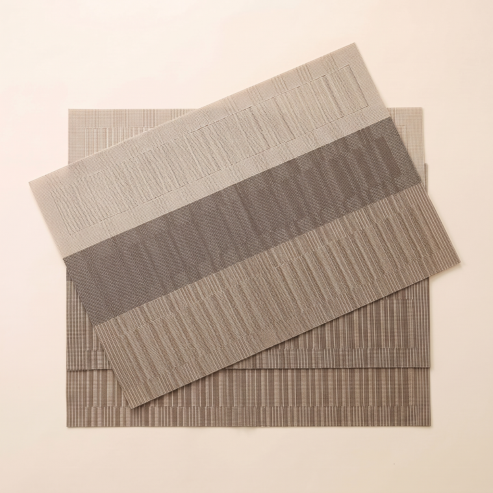 Woven Placemats – Wipe Clean in Brown &amp; Beige – Block Stripe – overhead flat lay of three overlapping mats, top one angled