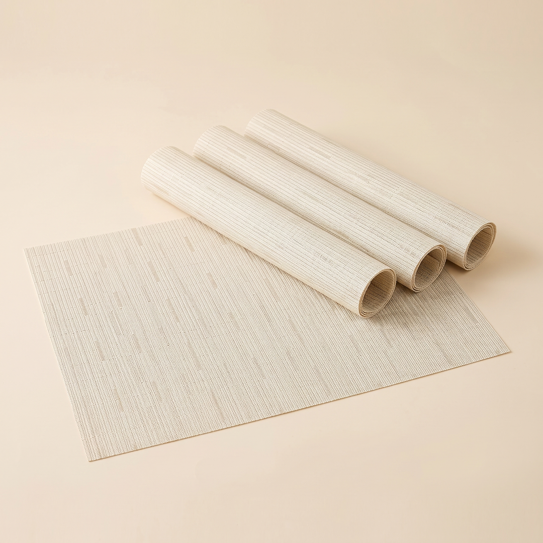 Woven Placemats – Wipe Clean in Cream – Dash Weave – one flat mat with three rolled mats on plain background