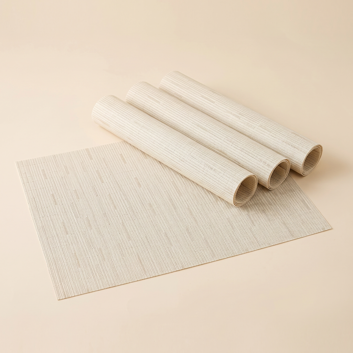 Woven Placemats – Wipe Clean in Cream – Dash Weave – one flat mat with three rolled mats on plain background