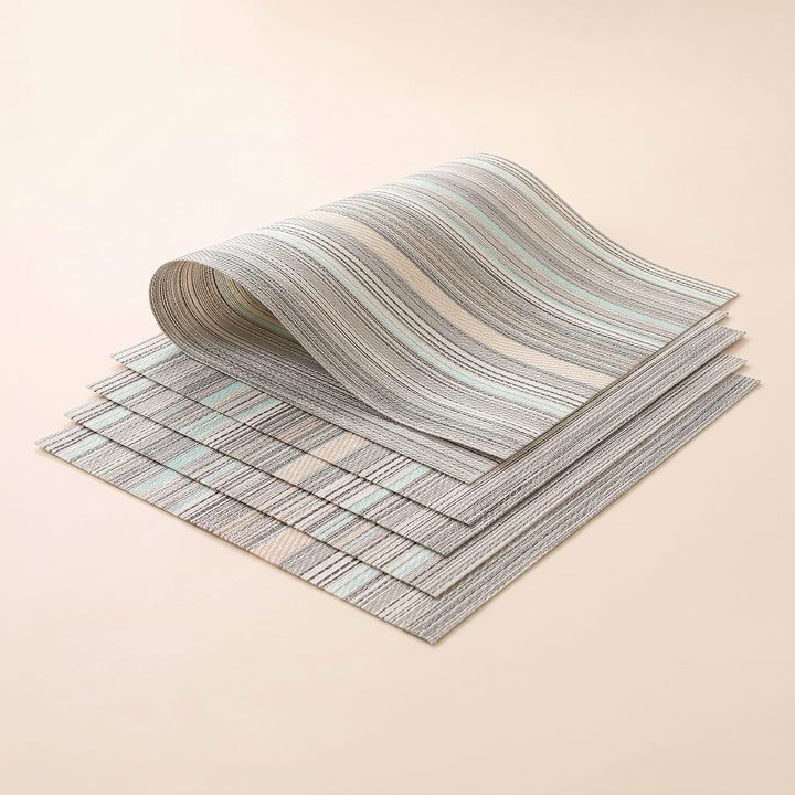 Woven Placemats – Wipe Clean in Mint – Stripe – top mat rolled into a loose wave over fanned stack