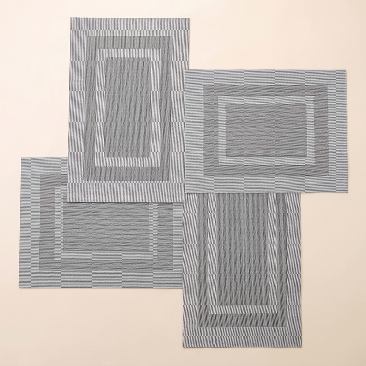 Woven Placemats – Wipe Clean in Silver – Frame – four mats alternating upright and sideways in a pinwheel arrangement