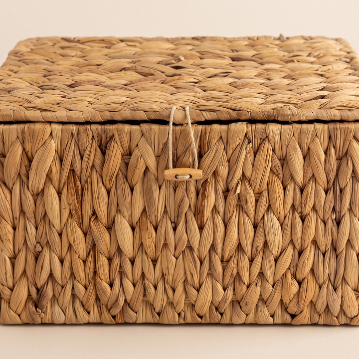 Woven Storage Basket with Lid in Brown – straight-on front view of the braided weave and wooden toggle clasp